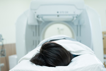 Asian radiologists explain treatment information to patients in x-ray room.CT (Computed tomography)...