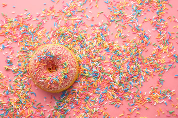 Top view of fresh and tasty donuts on pink 