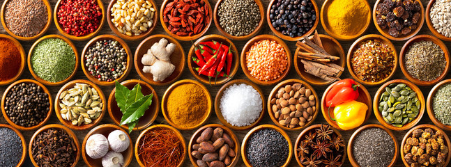 Colourful background from various herbs and spices for cooking in bowls