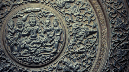 A close up of engraved people on wood