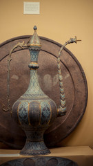 A close up of engraved tall teapot