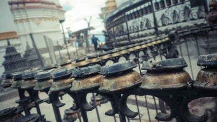 A close up of metal railing with gold