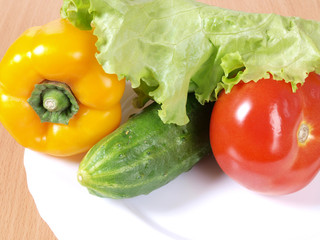 Red tomato sweet peppers on a plate. Ingredients for cooking
