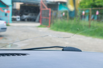 .close-up photo of a cracked windscreen, view from inside of the car