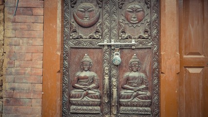 A door with engraved or faces and person