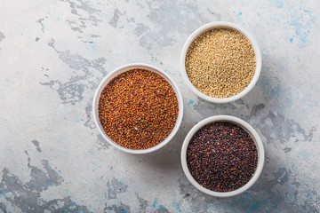 Black, red and white quinoa grains in a plate on white background. Gluten free Healthy food. Chenopodium quinoa closeup