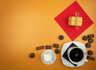 Chocolate candies and coffee with milk