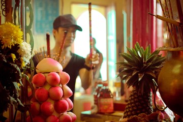 A person holding stick with close up of food