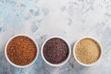 Black, red and white quinoa grains in a plate on white background. Gluten free Healthy food. Chenopodium quinoa closeup