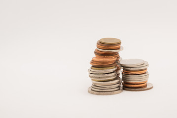 Coins stacked on a white background,