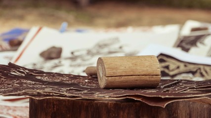 Carved brown paper with hammer on table