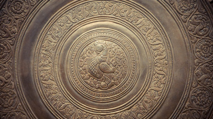 Close up of detail engraved on a metal