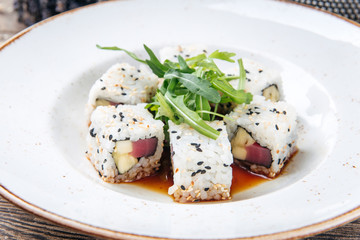 Tuna sushi rolls rice sesame seeds and soy sauce