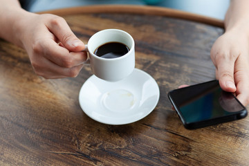  woman hand phone with coffee