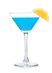 Blue lagoon summer cocktail in martini glass with orange slice on white.