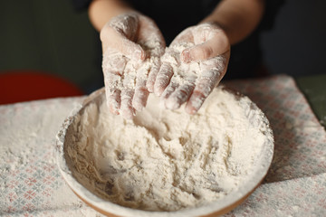 Little girl prepare the pie. Kid in the kitchen. Child with a flour.