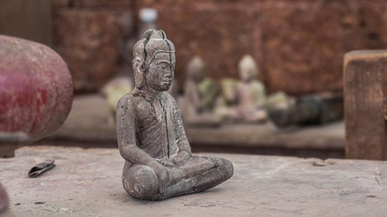 Fototapeta na wymiar Hand size statue of a man meditate