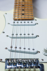 Fototapeta na wymiar White electric guitar on a white background. Pictured guitar deck 