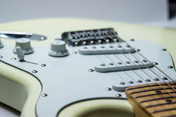 White electric guitar on a white background. Pictured guitar deck