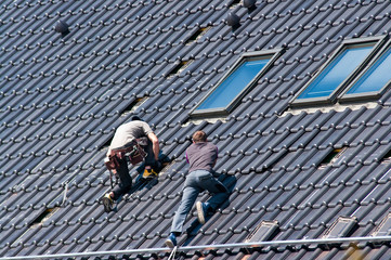 Installing solar panels on the roof of private house