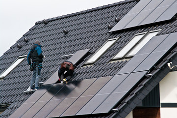Installing solar panels on the roof of private house