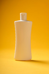 White bottle over yellow background