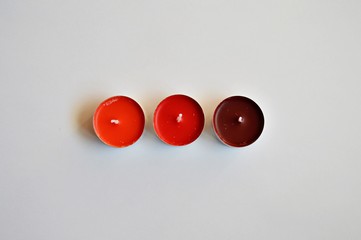 Three red candles on a white background