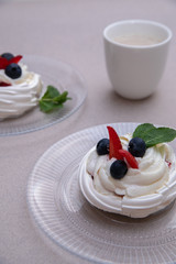 dessert Anna Pavlova on a beige background. Vertical photo. A photo for instagram stories. Photo for restaurant menu.
