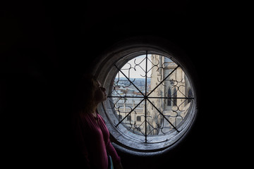 Woman looking through the ancient window