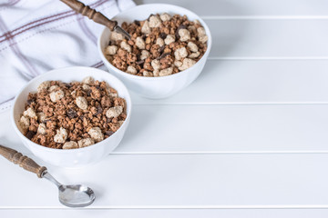 granola and bran in bowls on the table close-up. morning breakfast in the form of granola and bran.