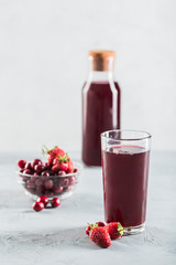 The concept of a summer refreshing drink made from red berries: berry Morse made from fresh strawberries and cranberries