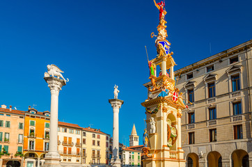 Fototapeta na wymiar Columns with winged lion and statues in Piazza dei Signori square, old historical city centre of Vicenza city, Veneto region, Italy