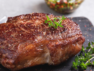 juicy beef steak, mutton roasted with asparagus on a cutting board, sauce close up