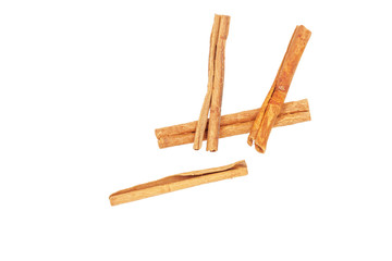 Three pieces of cinnamon lie on a white background, close-up.