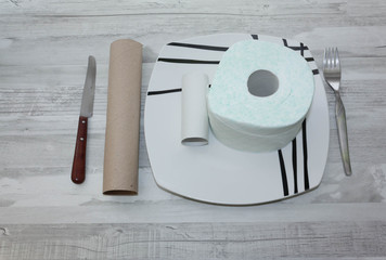 Plate with one roll of toilet paper and one empty