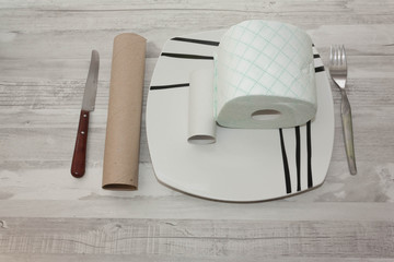 Plate with rolls of prepared toilet paper