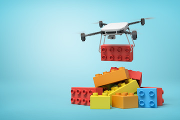 Fototapeta premium 3d rendering of quadcopter delivering huge red toy block and putting it on pile of other blocks on blue background.
