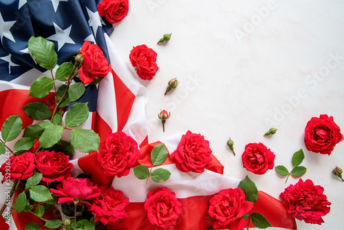 Red roses over the USA flag top view flat lay