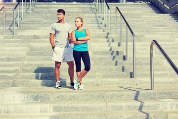 Young attractive couple standing in stairs
