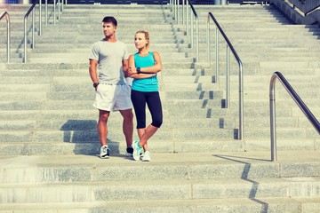 Fototapeta premium Young attractive couple standing in stairs 