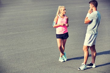 Young couple standing while talking after exercising
