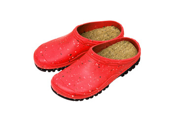 Rubber shoes isolate on a white back. Colored rubber slippers on a tractor sole. Shoes for the garden, beach and housework.