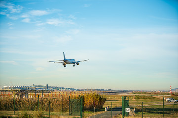 Fototapeta na wymiar BARCELONA, CATALUNYA, SPAIN - DECEMBER 13, 2017: Vueling company plane landing at El Prat airport, Barcelona.