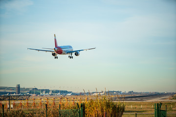 BARCELONA, CATALUNYA, SPAIN - DECEMBER 13, 2017: Iberia company plane landing at El Prat airport,...