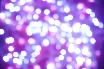 Fototapeta premium Blue lights on a purple background are blurred. Concept of blank frame,copy space. Christmas or new year flatlay background.