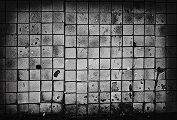 Ominous tiled grunge weathered old background.