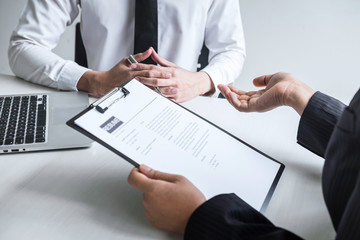 Employer arriving for a job interview, committee listen to candidate answers explaining about his profile and colloquy dream job, manager sitting in job Interview talking in office
