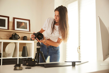 young professional photographer working in home studio
