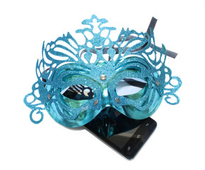 Smartphone under the mask as a symbol of anonymity on the Internet.