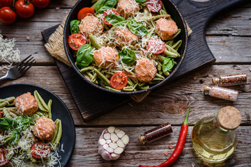 Delicious fresh pasta with meatballs, sauce, cherry tomatoes and basil